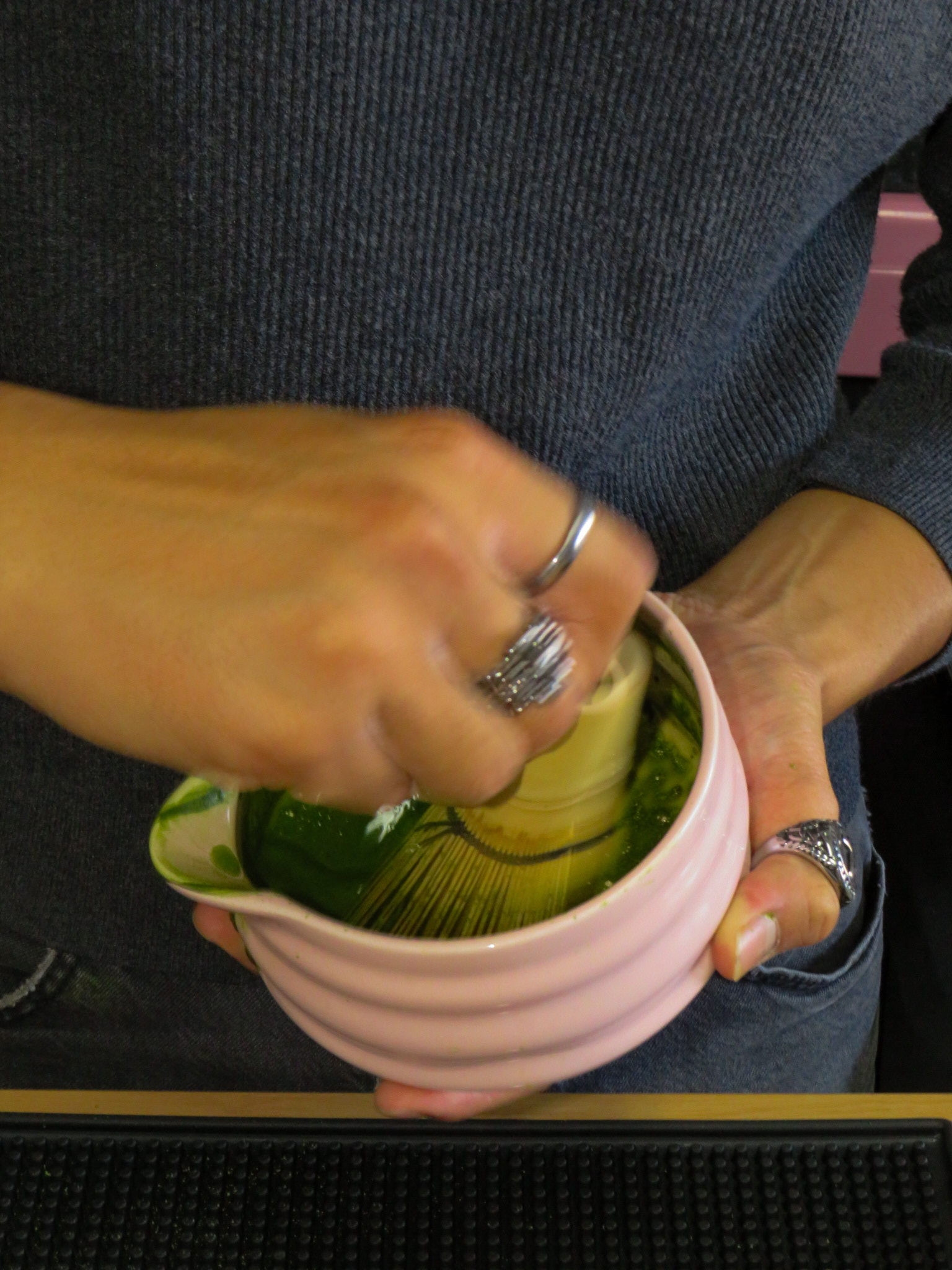 Whisking matcha in a pink UniTea bowl